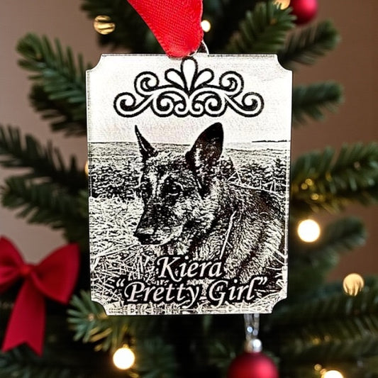 Decorative Christmas ornament with a dog illustration and text on a tree.