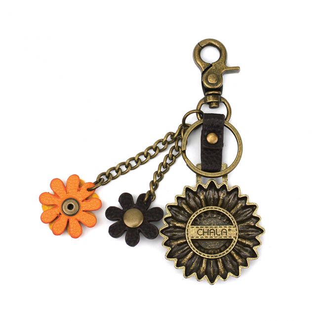 Conveniently small, fun, and functional. Hold your keys with style! Antique bronze toned Sunflower key chain. Comes with bonus flower leather charms. Easy to attach onto a bag, luggage, or keys! Materials: Metal, Vegan Leather. The perfect gift for sunflower and nature lovers.