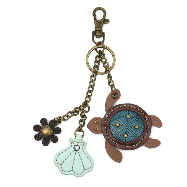 CHALA Mini Turtle Keychain, Purse Charm. Hold your keys with style! Faux leather Turtle mini keychain. Comes with bonus flower and shell charms! Easy to attach onto a bag, luggage, or keys! Materials: Metal, Vegan Leather